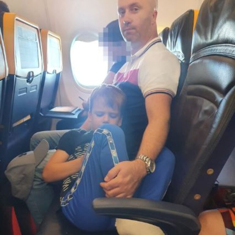 Ryan was comforted by his dad after being left in the aisle seat. Picture: Mirrorpix