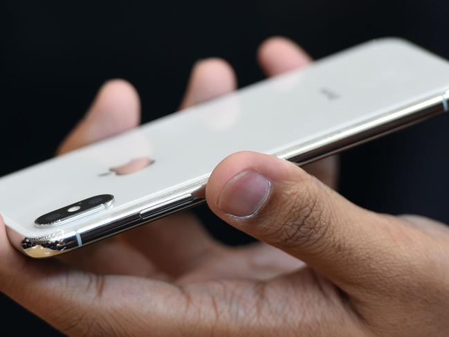 People try out the new iPhone X during a media event at Apple's new headquarters in Cupertino, California on September 12, 2017.  / AFP PHOTO / Josh Edelson