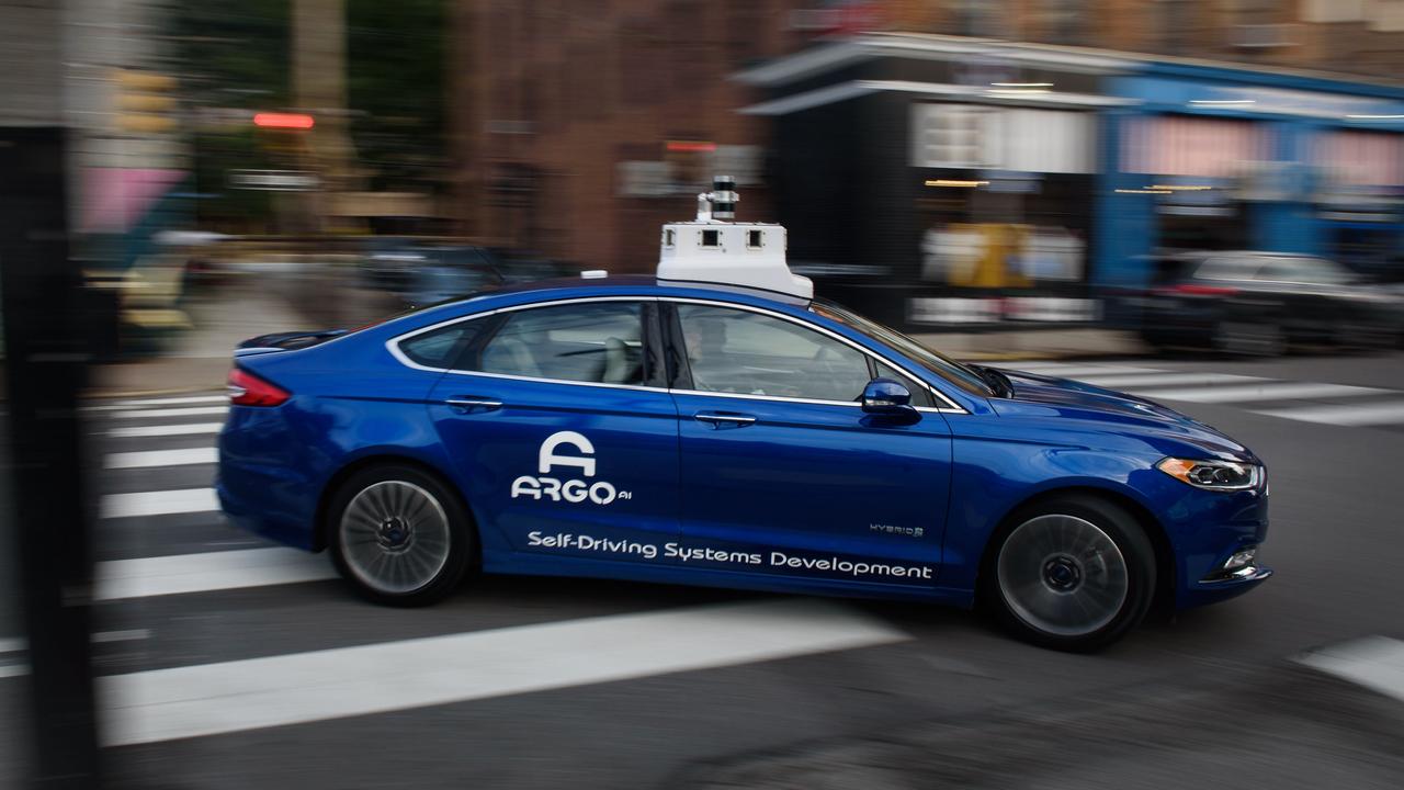 An Argo AI modified Ford Motor Co. Fusion autonomous vehicle is seen driving along a street near the company's headquarters in Pittsburgh, Pennsylvania. Photographer: Justin Merriman/Bloomberg