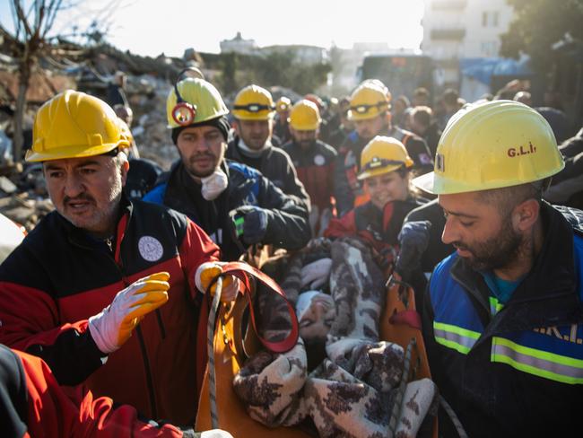 Rescue workers carry a survivor at the site of a collapsed building after 60 hours on from the earthquake in Hatay, Turkey. Picture: Getty Images