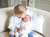 Britain's Princess Charlotte held by her brother,Prince George.