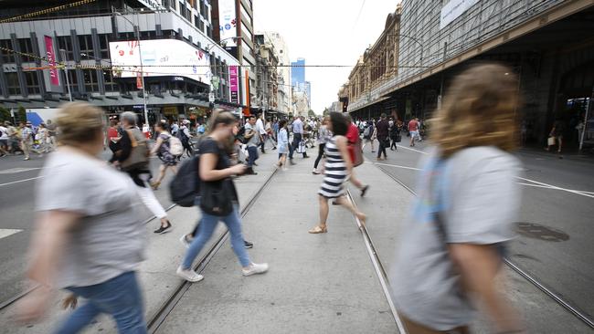 Pedestrians cross Flinders St near the scene of Thursday’s attack. Picture: David Caird