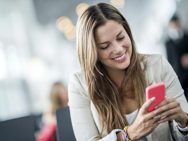 Happy woman texting on her smartphone. Picture: iStock.