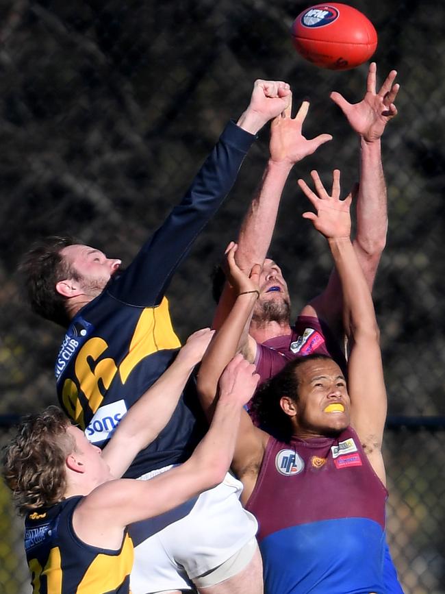 Luke Deards attempts to punch the ball away. Picture: Andy Brownbill