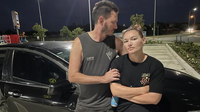 Tim (left) and his partner at Aldi Andergrove, where his stolen SS Commodore was left, extremely damaged, after a joyride through Mackay and the Pioneer Valley. Picture: Paul Brescia