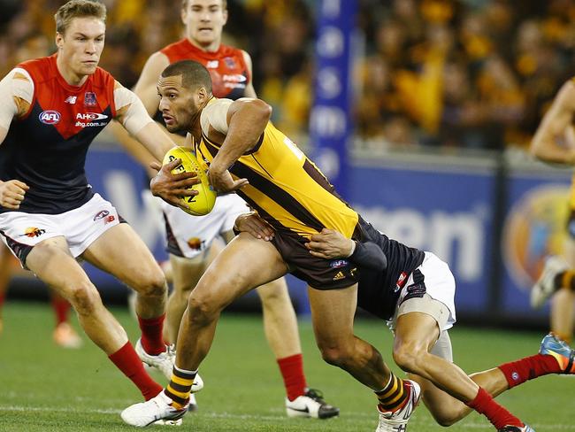 Josh Gibson attempts to escape a Dom Barry tackle. Pic: Michael Klein. Saturday August 9, 2014.