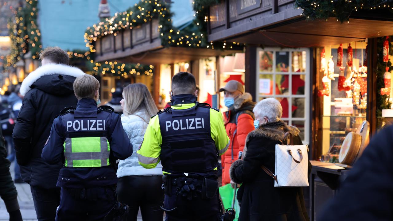 Police officers patrol the annual Christmas market at Alter Markt in Cologne, Germany during the fourth wave of the Covid pandemic on November 23. Picture: Andreas Rentz/Getty Images