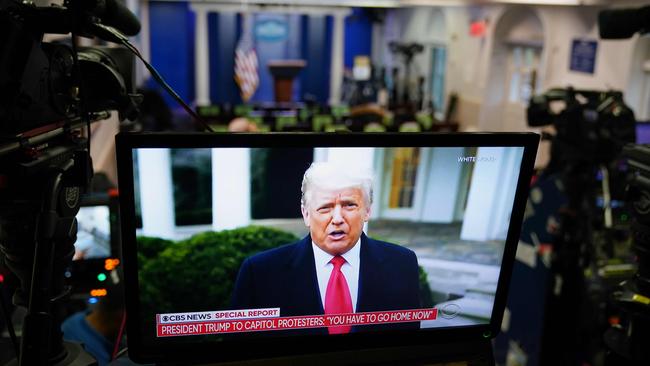 US President Donald Trump is seen on TV from a video message released on Twitter, seen in an empty Brady Briefing Room at the White House in Washington.