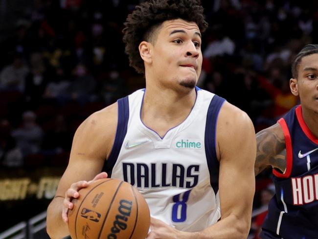 HOUSTON, TEXAS - JANUARY 07: Josh Green #8 of the Dallas Mavericks drives passed Kevin Porter Jr. #3 of the Houston Rockets during the second half at Toyota Center on January 07, 2022 in Houston, Texas. NOTE TO USER: User expressly acknowledges and agrees that, by downloading and or using this photograph, User is consenting to the terms and conditions of the Getty Images License Agreement. (Photo by Carmen Mandato/Getty Images)