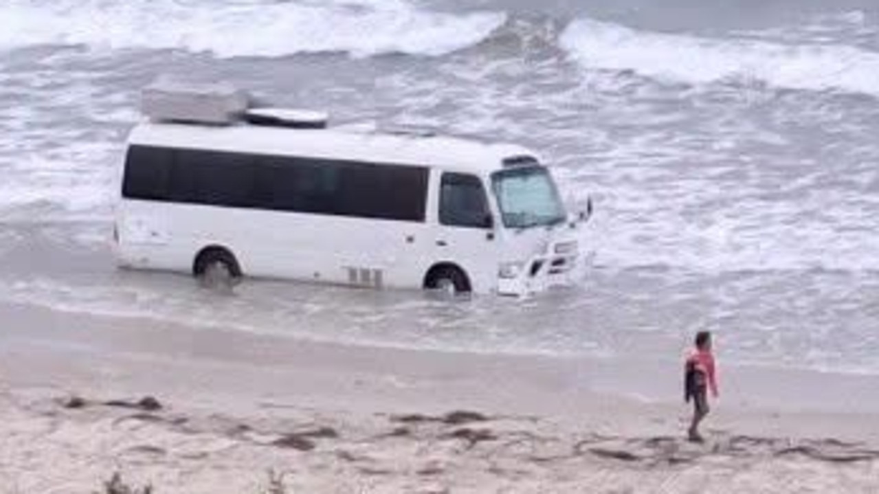 Bizarre sight of bogged bus at beach