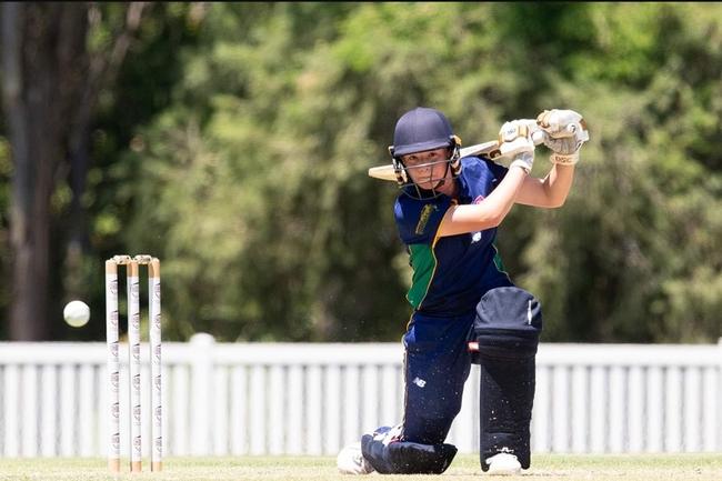 Rising cricket star Annika Bjorkman drives the ball to the fence.