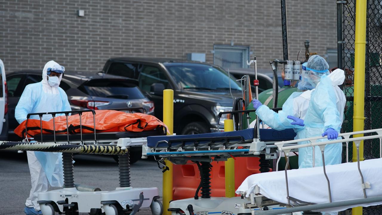 Bodies are moved to a refrigerator truck serving as a temporary morgue outside of Wyckoff Hospital in the Borough of Brooklyn, New York. New York State's coronavirus toll rose to 3565 deaths Saturday. Picture: AFP