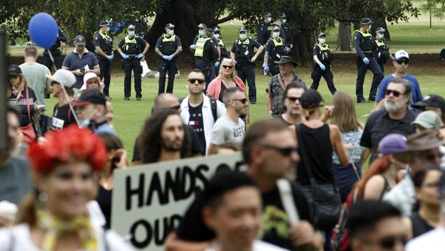 Police watch on during the rally in Fawkner Park. Picture: David Geraghty