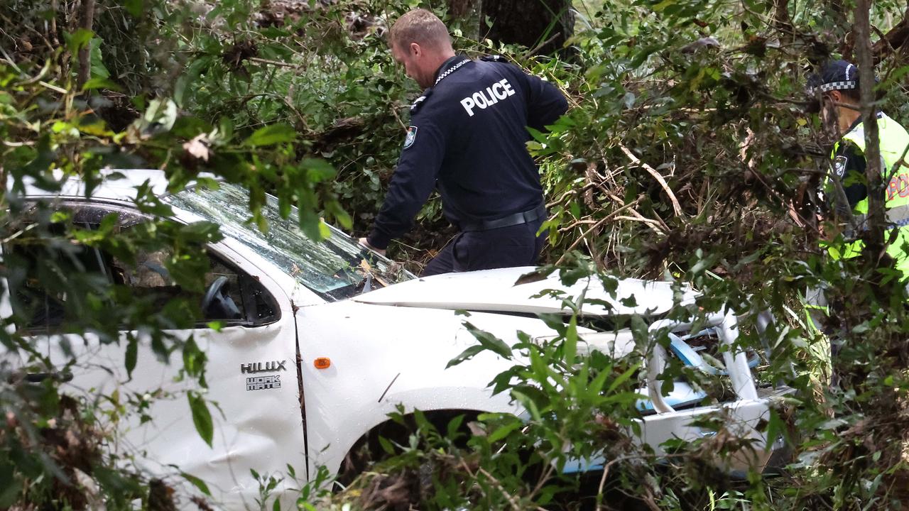 Police investigate the death of a man after his body was found near his car following heavy rain in Greenbank on Wednesday night. Picture: Liam Kidston