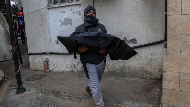 A man holds the body of a child following Israeli air strikes. Picture: Getty Images