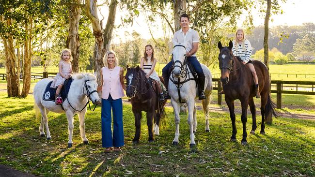 Elisha Hopkinson and her husband Sam, on Pistol, with their three daughters, from left, Milla, 4, on Stormy, Imogen, 8, on Boomer, and Sienna, 10, on Nadal, at their farm in Richmond, on Sydney’s rural outskirts. Elisha and Sam wear Sportscraft throughout. Picture: Hugh Stewart