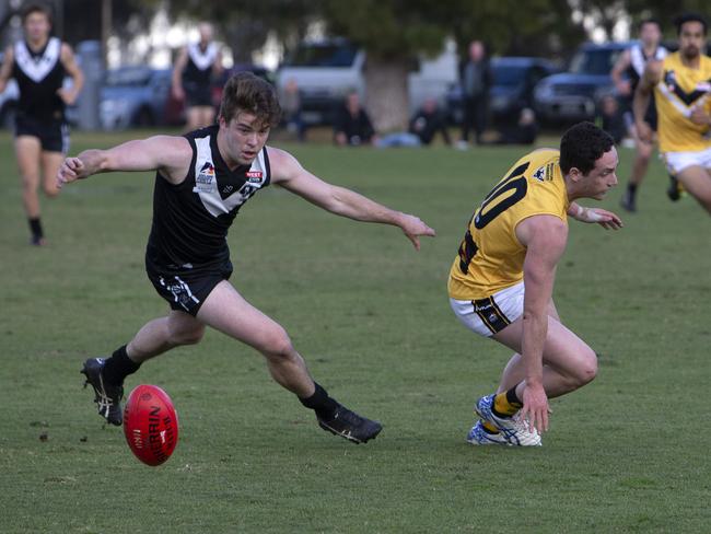 Blacks Player Hamish Wallace and Bombers Player Jack Plenty in play. Adelaide Footy League division one match between The Blacks Adelaide University Football Club Coach (Ben Watkins) and Brighton Bombers Football (Coach Joel Tucker) at University Oval (Park 12), Adelaide. Photographer Emma Brasier