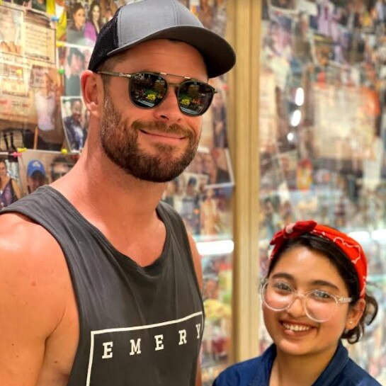 Hemsworth poses with store staff. Picture: Supplied