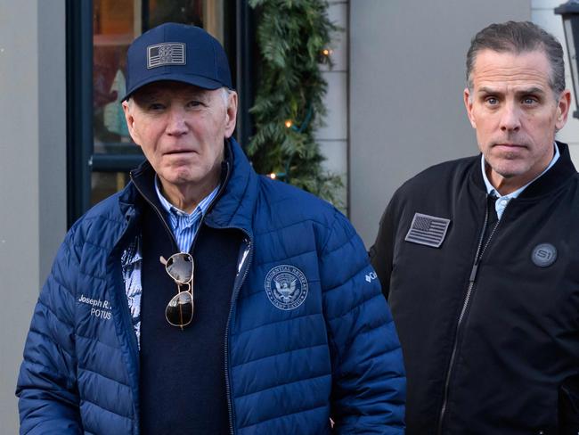 A November 29, 2024 photo shows US President Joe Biden and son Hunter Biden stepping out of a bookstore while shopping in Nantucket, Massachusetts on November 29, 2024. Biden on Sunday issued an official pardon for his son Hunter, who is facing sentencing for two criminal cases related to tax evasion and the purchase of a firearm. (Photo by Mandel NGAN / AFP)