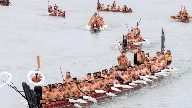 Traditional waka paddle down the Waitangi River on Waitangi Day. Picture: AAP.