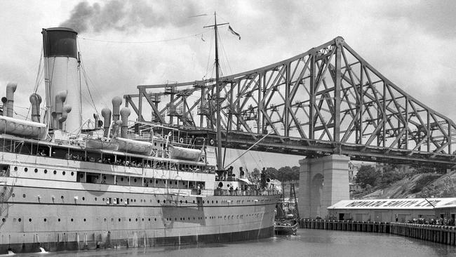 Pictured in January 1939, The Coastal steamer Canberra swinging with assistance from the tug Forceful before berthing in the Brisbane River under the shadow of the Story Bridge construction site.