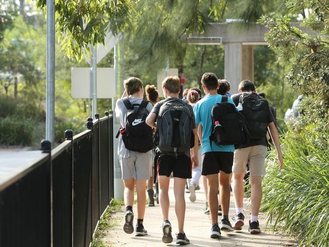 DAILY TELEGRAPH - Pictured are kids leaving Lindfield Learning Village today where Primary School classes are displaying student-made posters in emblazoned with the words ``stop killer cops" and "pigs out of the country". Picture: Tim Hunter.