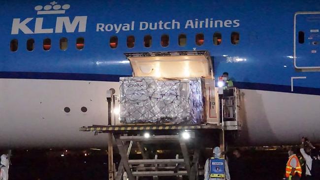 Workers in Manila unload containers carrying AstraZeneca vaccines from a passenger plane from Europe. Picture: AFP