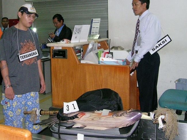 Andrew Chan re-enacting at Ngurah rai Airport the night he was arrested preparing to board a plane for Sydney.