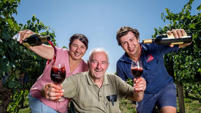 Linda Newton, Gino Corsini and Reuben Corsini pour wine among the vines at La Cantina Winery. Picture: Jake Nowakowski