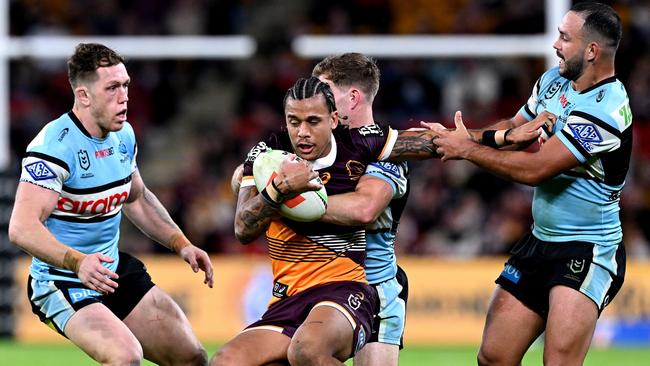 BRISBANE, AUSTRALIA - JUNE 08: TristanÃÂ Sailor of the Broncos is tackled during the round 14 NRL match between Brisbane Broncos and Cronulla Sharks at Suncorp Stadium, on June 08, 2024, in Brisbane, Australia. (Photo by Bradley Kanaris/Getty Images)