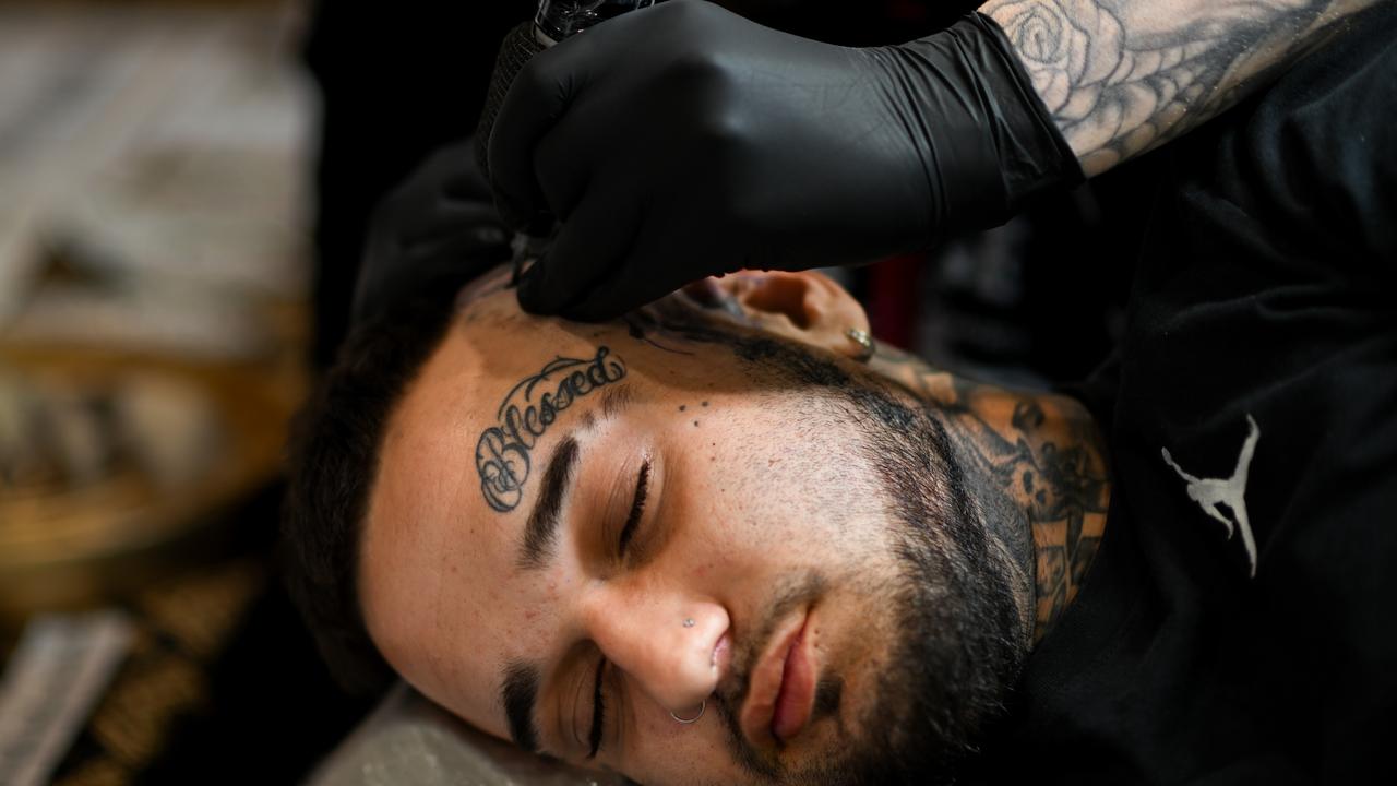 A tattoo enthusiasts receives a facial tattoo at the Australian Tattoo Expo in Brisbane. Picture: Dan Peled / NewsWire