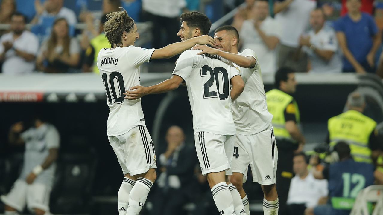 Real midfielder Marco Asensio, center, celebrates with Luka Modric, left, and Dani Ceballos