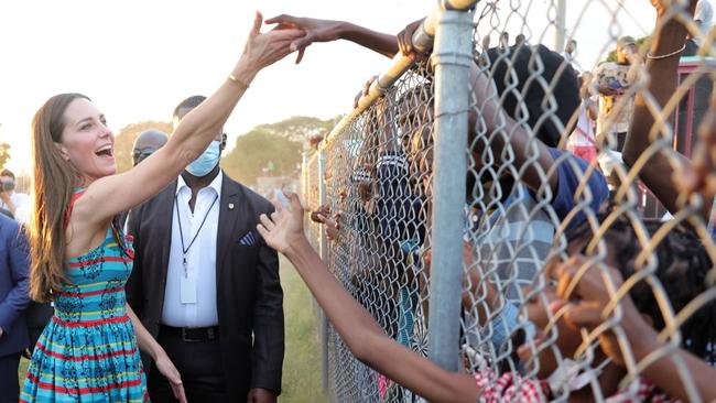 A firestorm has erupted around this photo of Kate Middleton shaking hands with children through a fence during a visit to Trench Town, Jamaica. Picture: Chris Jackson-Pool/Getty Images.