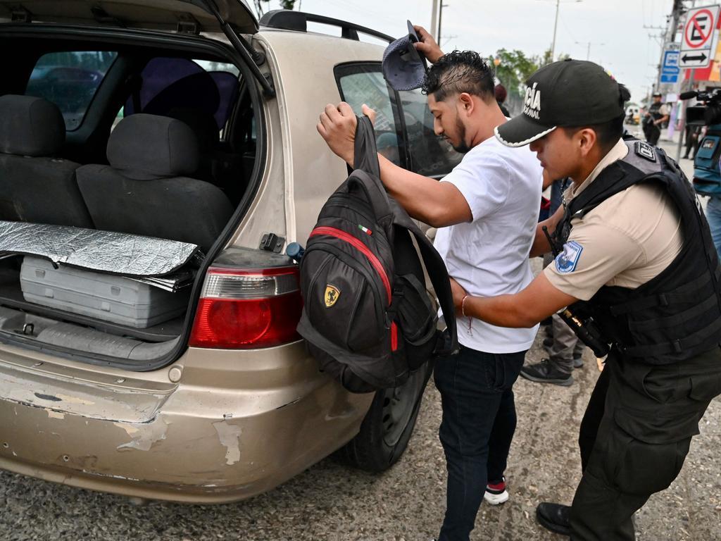 A police officer frisks a man during a security operation in Guayaquil, Ecuador on April 1.