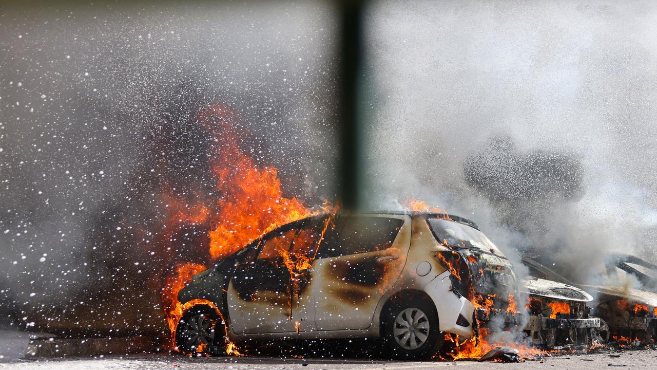 Cars are seen on fire following a rocket attack from the Gaza Strip. Picture: AFP