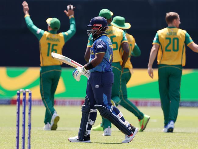 NEW YORK, NEW YORK - JUNE 03: Charith Asalanka of Sri Lanka makes his way off after being dismissed during the ICC Men's T20 Cricket World Cup West Indies & USA 2024 match between Sri Lanka  and South Africa at  Nassau County International Cricket Stadium on June 03, 2024 in New York, New York. (Photo by Robert Cianflone/Getty Images)