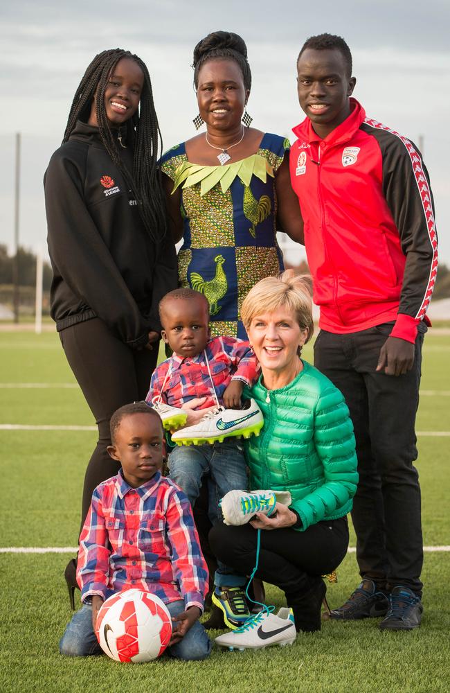 Former foreign minister Julie Bishop with Awer Mabil, right, with his sister Bor, left, mum Agot Atem, centre, brothers Deng and Dau for the Barefoot to Boots initiative in 2015. Picture: JAMES ELSBY