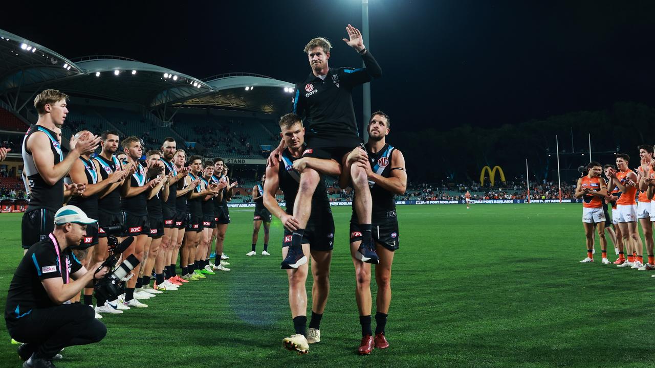 ADELAIDE, AUSTRALIA - SEPTEMBER 16: Tom Jonas of the Power is chaired off by Ollie Wines and Travis Boak after his last game during the 2023 AFL Second Semi Final match between the Port Adelaide Power and the GWS GIANTS at Adelaide Oval on September 16, 2023 in Adelaide, Australia. (Photo by James Elsby/AFL Photos via Getty Images)