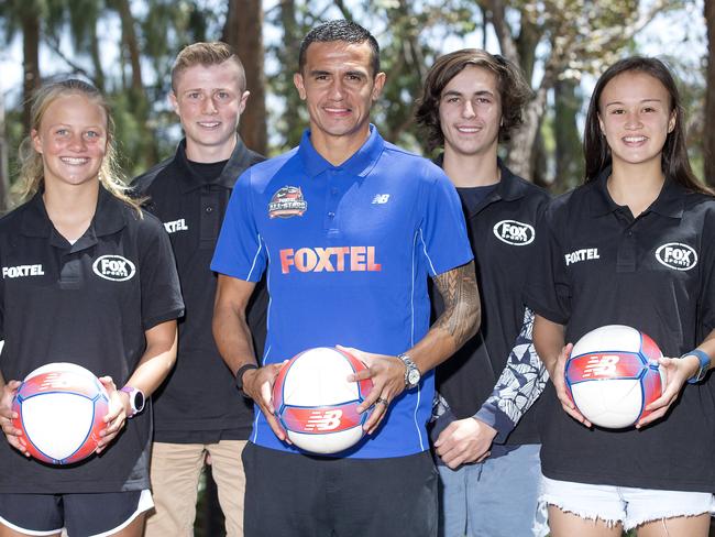 Young footballer Amy Sayer, right, at a Foxtel All-Stars camp with Tim Cahill.