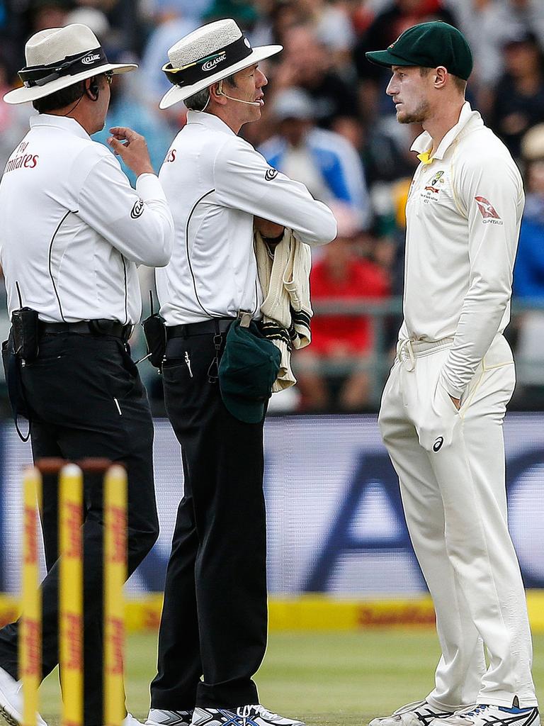 Umpires confront Cameron Bancroft. Picture: AFP/Gianluigi Guercia