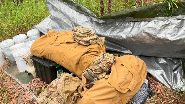 Images of a makeshift bush hut discovered by Australian Defence Force members in Mount Baldy Forest Reserve, which police allege contained weapons, food, and child exploitation material. A 48-year-old Kanimbla man has been arrested and charged with two counts of possess child exploitation material and one count of unlawful possession of weapons category E.