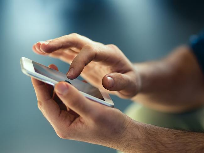 Generic Male hands typing on smartphone. Picture: Istock