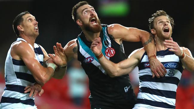 Charlie Dixon is wrapped up by Geelong defenders in a familiar sight against the Cats.