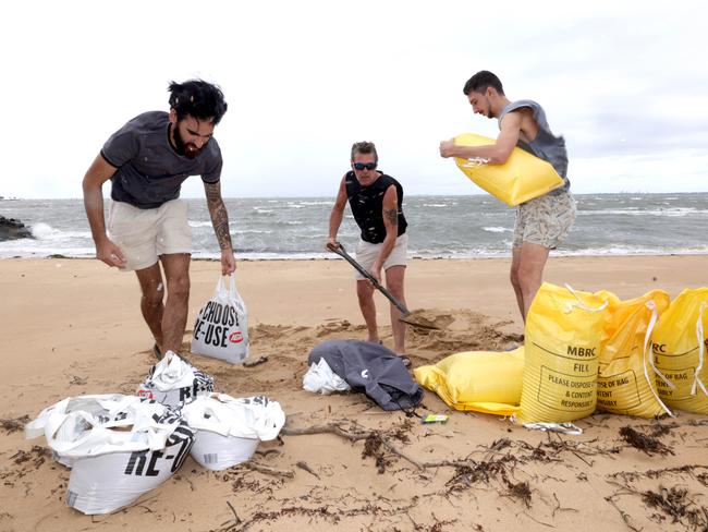 Elijah Kereama, Jamie Irvine, Josh Irvine, on Woody Point getting sand bags filled, ahead of Cyclone Alfred. Photo Steve Pohlner