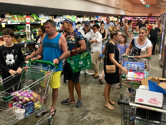 Not browsing, lining up... the queue stretches up and down aisles at Woolworths DFO Brisbane yesterday.