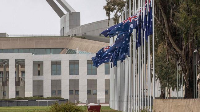 Australian flags fly at half-mast outside Parliament House in Canberra. Picture: AFP