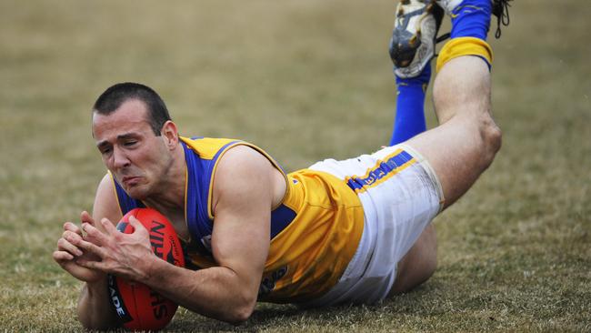 Tory Dickson takes a diving mark for Noble Park in the Eastern Football League.