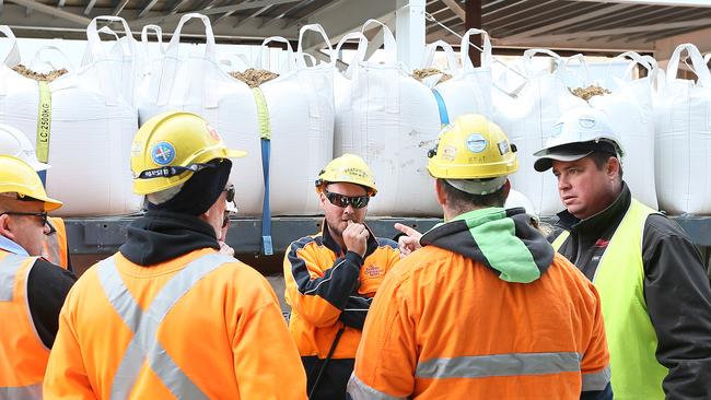 Workers discuss options next to a truck loaded with sandbags in Murray St. Picture: SAM ROSEWARNE.