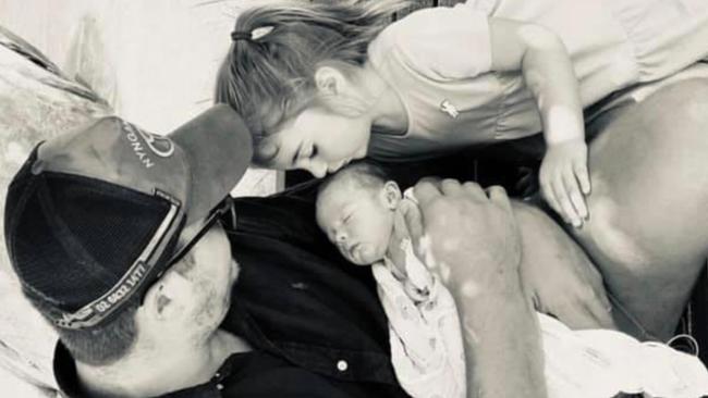 Hermidale farmer and publican Michael Wells-Budd with daughter Charlotte Rose, 2, and baby Thomas who is battling cancer.