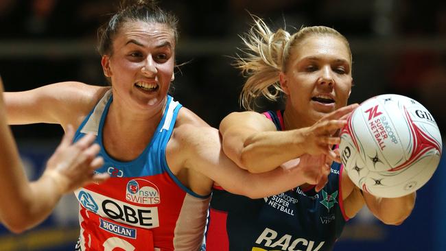 Maddy Proud and Vixens Kate Moloney battle for the ball.